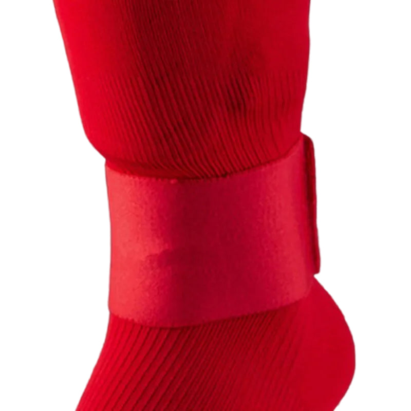 Red ankle strap securing shin guard under football sock
