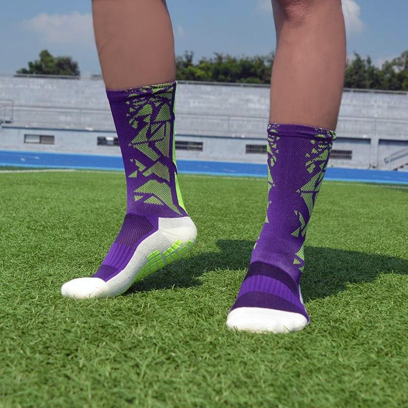 Purple and green anti-slip football grip socks worn on artificial turf